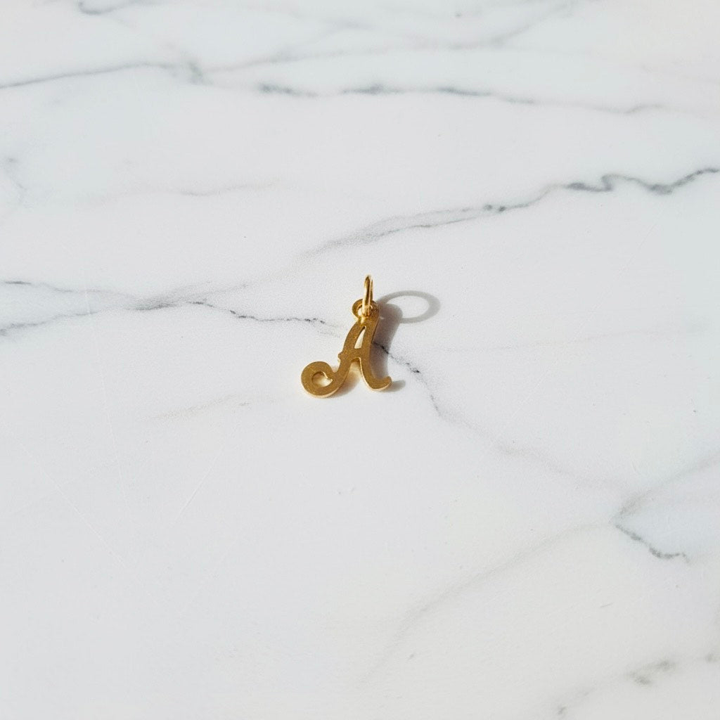 Aquamarijn armband met gouden muntjes en letter